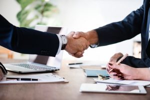 Handshake - making a good deal is the best way to cut moving costs.