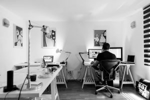 Black & white image of a guy in his home office