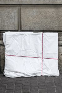 A painting wrapped in a white sheet