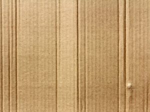 A cardboard texture, as one of the reasons to use plastic bins when moving home.