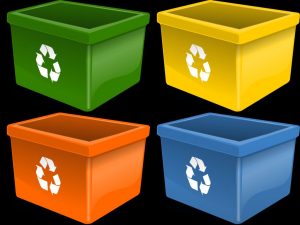 Four plastic bins with recycling signs, in different colors.