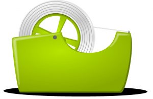 A green holster for packing tape, with some inside.