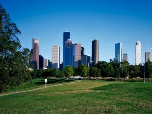 A view of downtown Houston from a park.