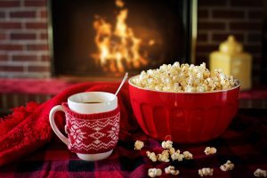 cup of tee and popcorn near the fireplace