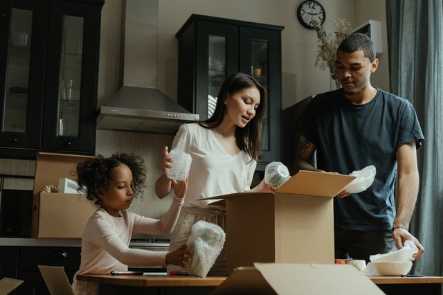 Family packing for the move after learning why do Americans move so much more than Europeans