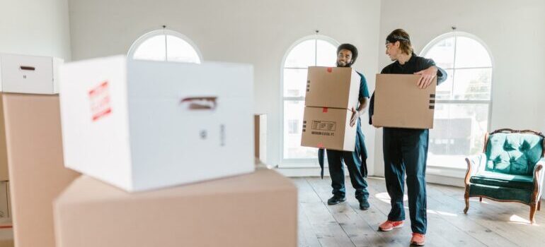 movers holding boxes