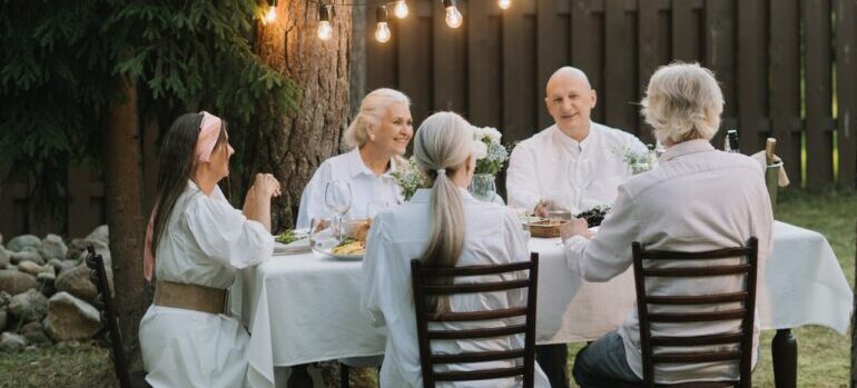 A group of elderly people having dinner.