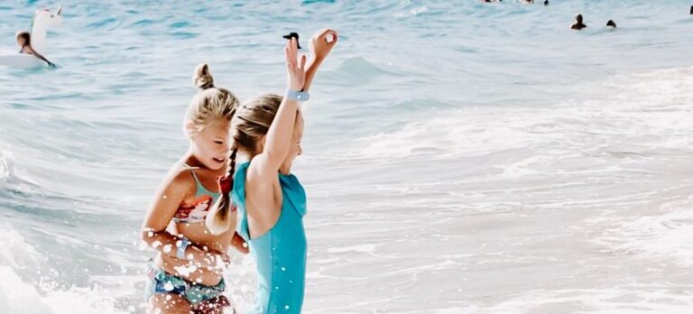 Two young girls having fun in the ocean.
