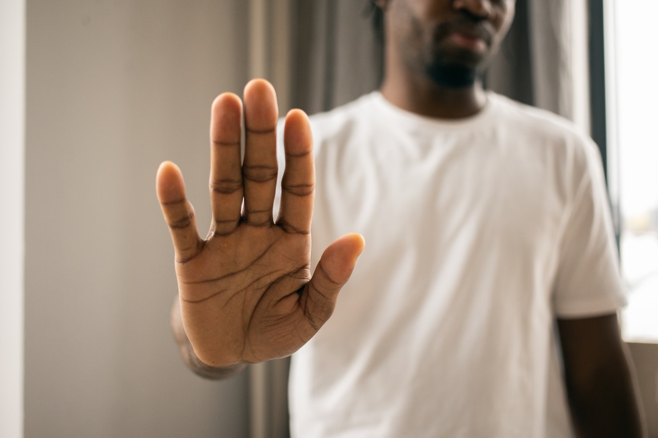 A man showing stop gesture with a hand as a symbol of items that your movers won't move