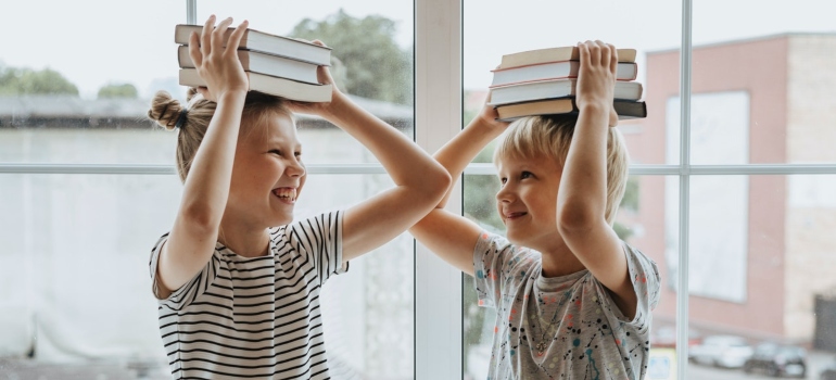 Children hold books on their heads.