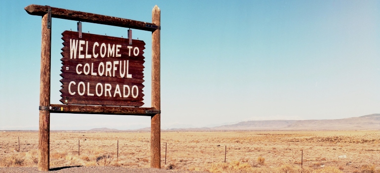 A sign on the road that says "Welcome to colorful Colorado".