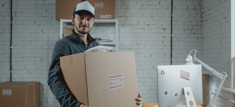 A man holding a box labelled "fragile"